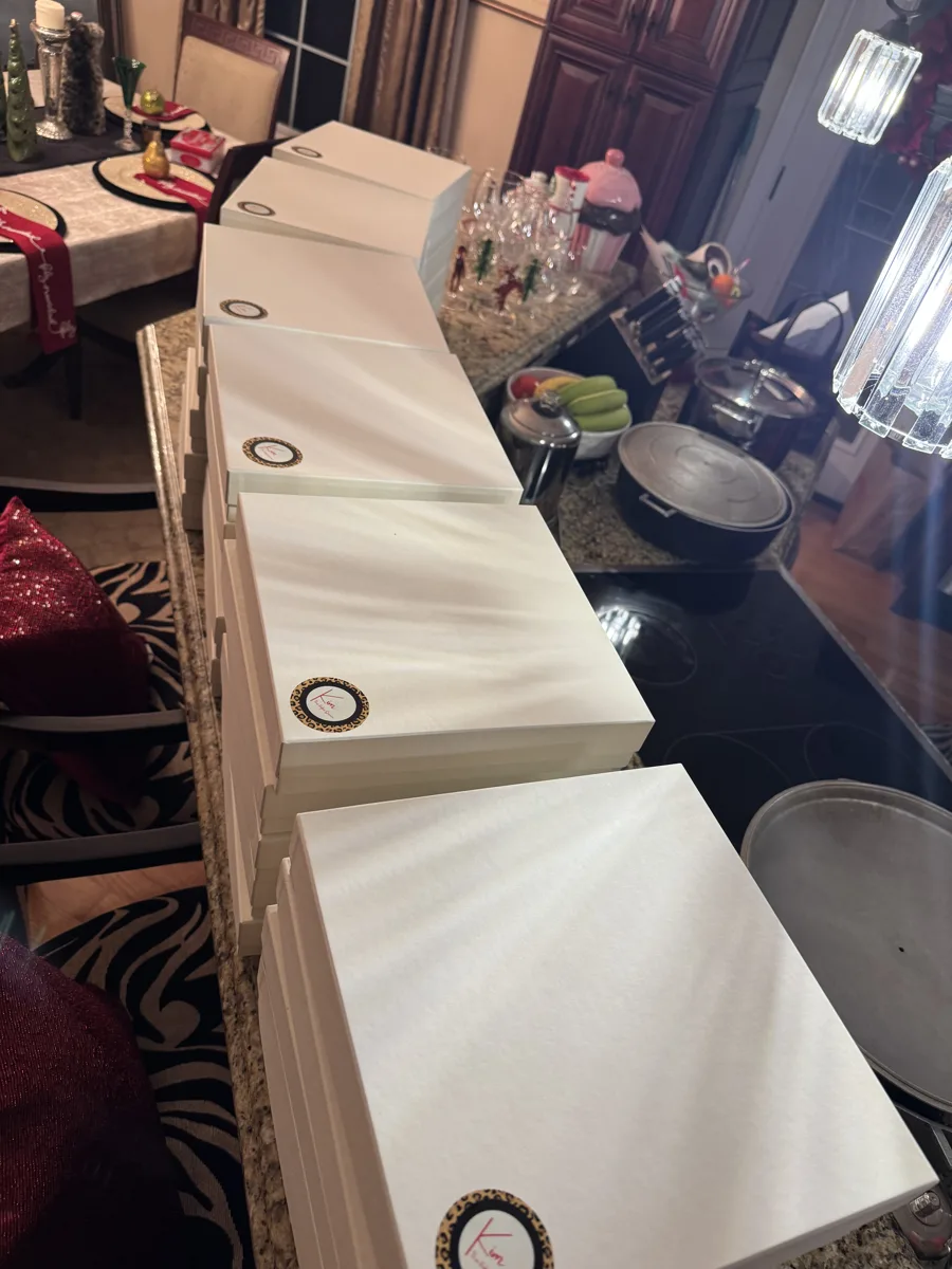Queen Zuri bakery boxes lined up on Kim’s kitchen counter