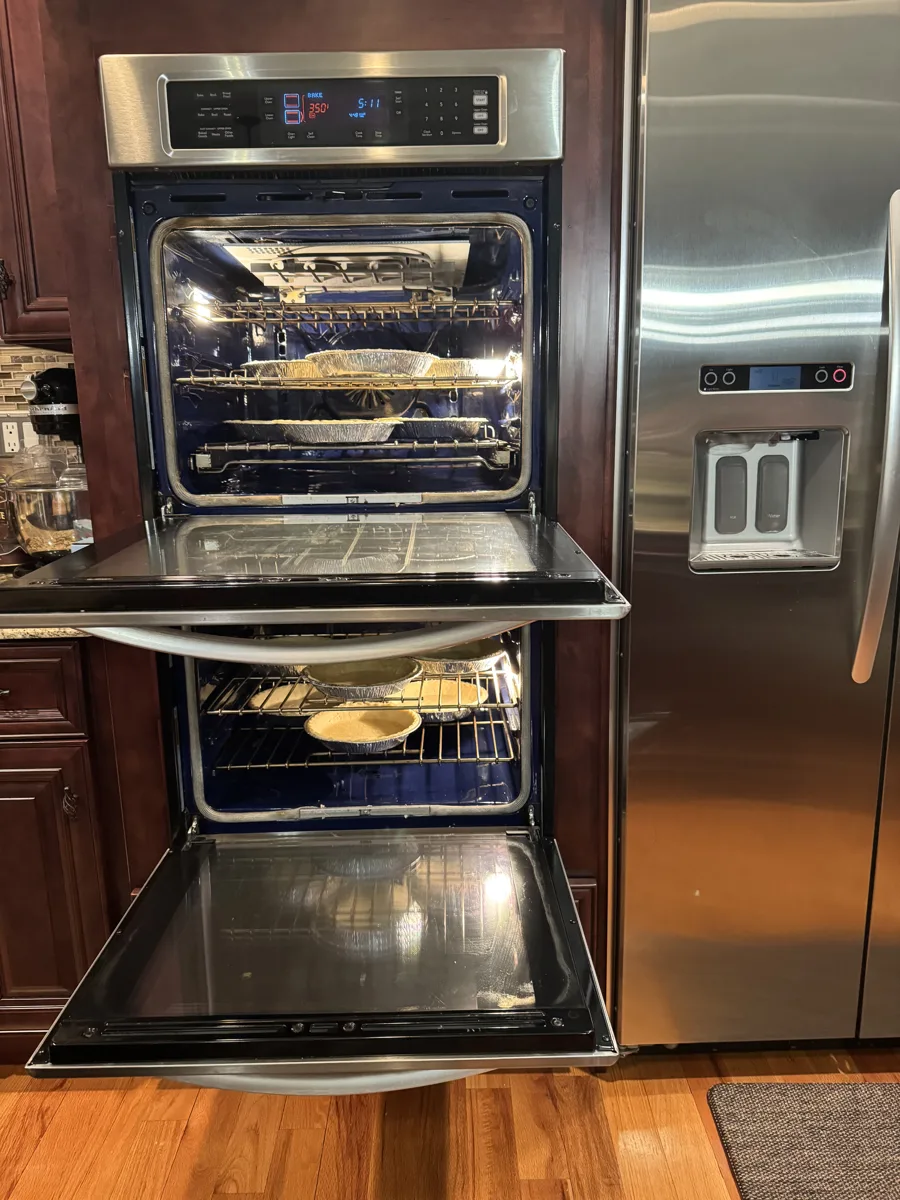 Queen Zuri sweet potato pies baking in two ovens in Kim’s kitchen